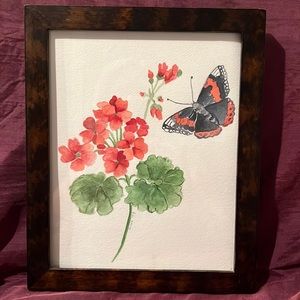 Watercolor painting by Julia ‘09 with a butterfly lurking around.